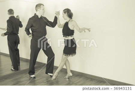 Couple of dancers dancing latin dances 36943131