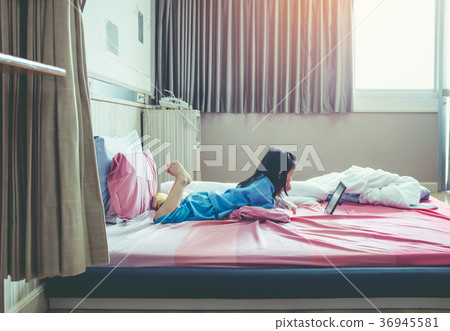 Cute asian child using tablet with iv drip on hand 36945581