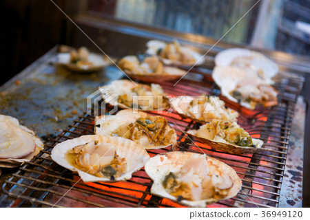 Grilled scallop with the seashell on stove  36949120