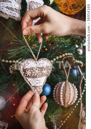 Hipster hands with Christmas sackcloth heart Hipster hands with Christmas sackcloth heart 36954169