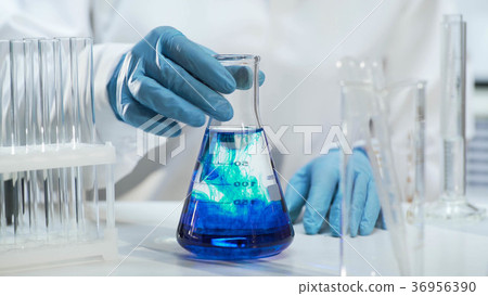 View of conical flask with liquid changing color View of conical flask with liquid changing color 36956390