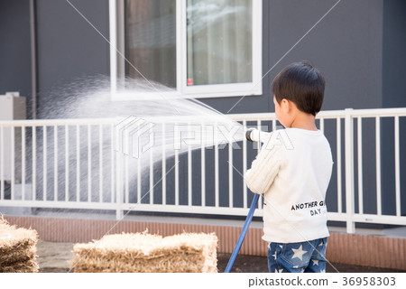 Children watering in the garden Children watering in the garden 36958303