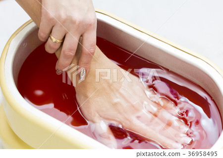 Process paraffin treatment of female hands in beau 36958495
