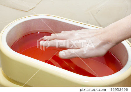 Process paraffin treatment of female hands in beau Process paraffin treatment of female hands in beau 36958496