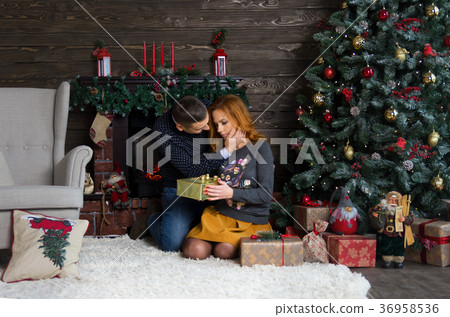 Happy young people give each other gifts Happy young people give each other gifts 36958536