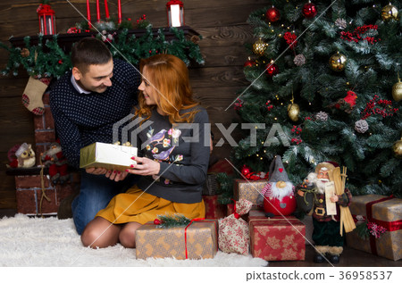 Happy young people give each other gifts Happy young people give each other gifts 36958537