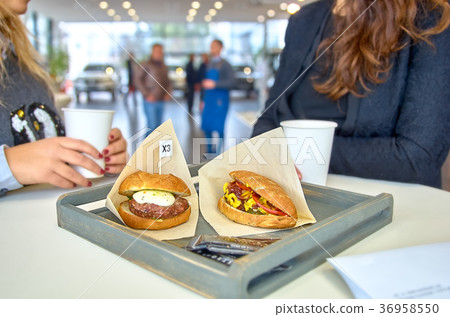 two women chatting during lunch. two women chatting during lunch. 36958550