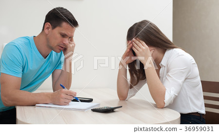 Desperate couple calculating financial losses 36959031