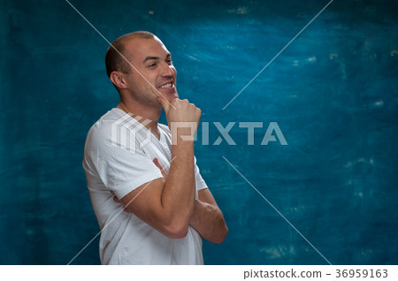 Cute man posing on blue background Cute man posing on blue background 36959163
