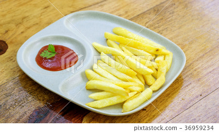 ketchup and french fries on a wooden table. ketchup and french fries on a wooden table. 36959234