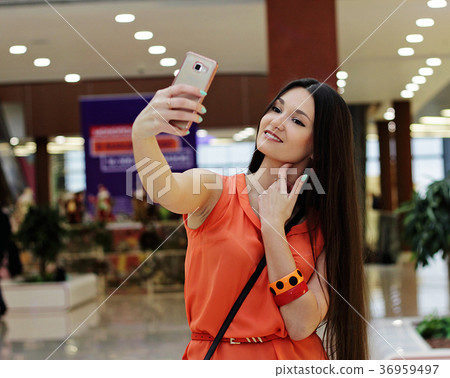 A beautiful girl takes pictures of herself. 36959497