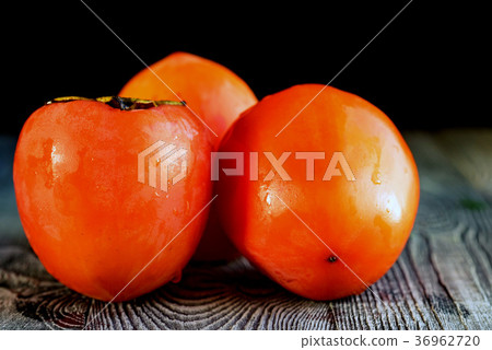 Ripe persimmons with water drops. Selective focus 36962720
