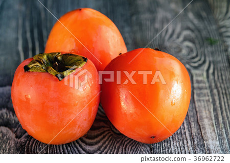 Ripe persimmons with water drops. Selective focus 36962722