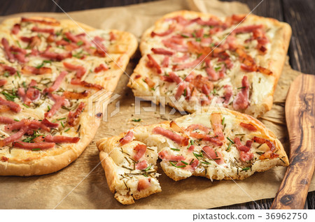 Tarte flambee, traditional alsatian pizza. Tarte flambee, traditional alsatian pizza. 36962750