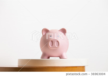 Pink piggy-bank on the table 36963004