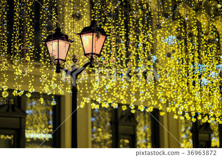 Metal lantern on background of shiny neon garland Metal lantern on background of shiny neon garland 36963872