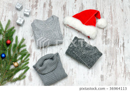 Three gray sweaters, Santa's hat and fir branch 36964113