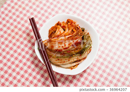 Kimchi with chopsticks in a dish Kimchi with chopsticks in a dish 36964207