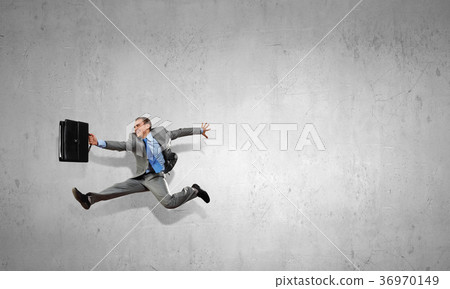 Businessman on cement background 36970149