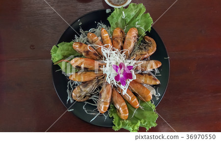 Grilled prawns on the plate. 36970550