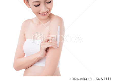 Woman applying lotion on arm over white Woman applying lotion on arm over white 36971111