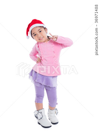 girl wearing santa hat stand and smiles over white 36971488