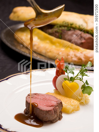 Image of luxurious roast beef pie with sauce poured on Image of luxurious roast beef pie with sauce poured on 36971500