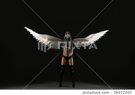 Conceptual shot of a sexy woman with white wings 36972093