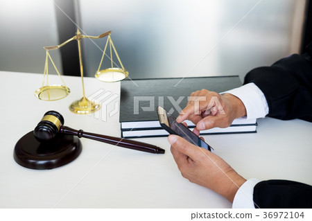 lawyer hand using smart phone in court (justice, law) with sound lawyer hand using smart phone in court (justice, law) with sound 36972104