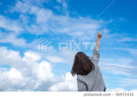 Woman pushing arms up Woman pushing arms up 36972416