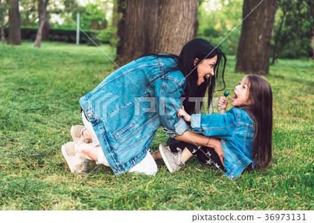 mom and daughter on the lawn have fun mom and daughter on the lawn have fun 36973131