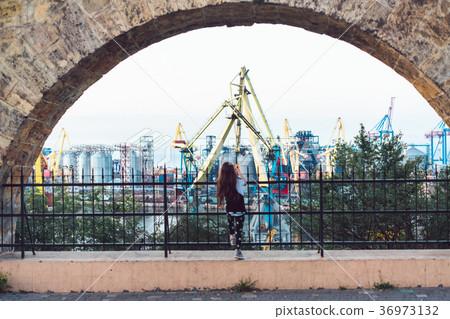 Little girl playing at fence 36973132