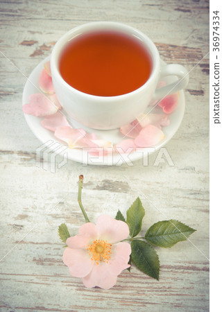 Cup of tea and wild rose flower Cup of tea and wild rose flower 36974334