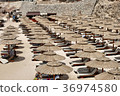 Beach with sun loungers and umbrellas 36974580