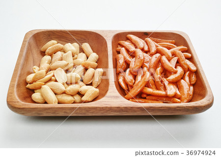 Duck seeds and peanuts on a wooden plate Duck seeds and peanuts on a wooden plate 36974924