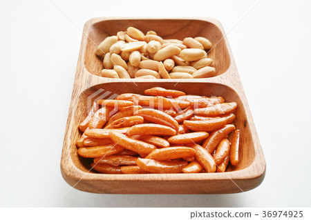 Duck seeds and peanuts on a wooden plate Duck seeds and peanuts on a wooden plate 36974925
