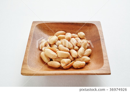 Peanuts on a wooden plate 36974926