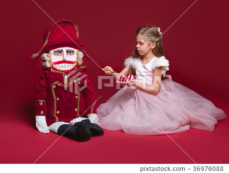 The beauty ballerina standing with nutcracker The beauty ballerina standing with nutcracker 36976088