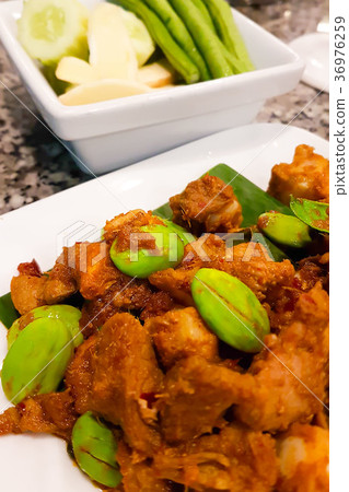 Pork rib stirred with curry paste and Parkia. Pork rib stirred with curry paste and Parkia. 36976259