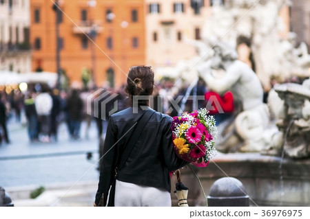 Woman with bunch of flowers in Piazza Navona, Rome 36976975