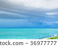 Dramatic before storm view at a turquoise lake 36977777