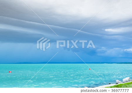 Dramatic before storm view at a turquoise lake 36977777