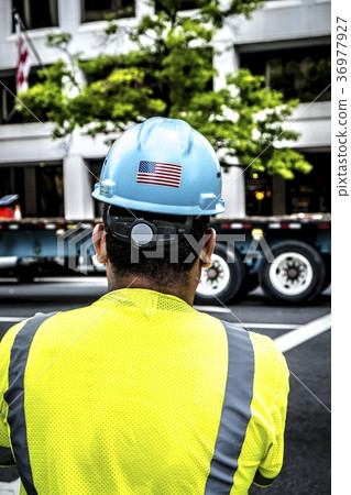 Worker wearing blue safety helmet with US flag 36977927