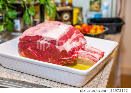 Raw beef Rib steak with bone in roasting tray on 36978132
