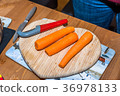 Fresh clean carrots with knife on heart shaped 36978133