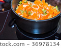 Fresh carrots and onions frying in pan casserole 36978134