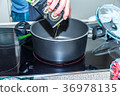 Closeup view pouring vegetable olive oil into 36978135
