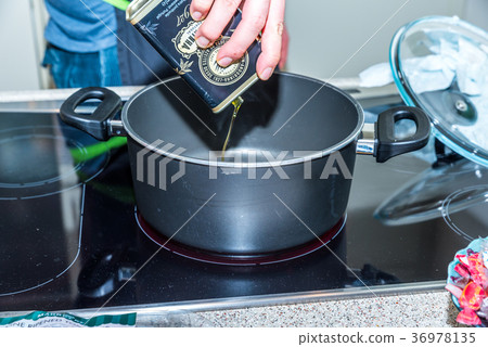 Closeup view pouring vegetable olive oil into 36978135