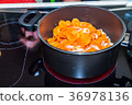 Fresh carrots and onions frying in pan casserole 36978136