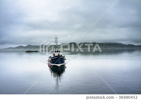 Alone boat driving through in the foggy sea in the Alone boat driving through in the foggy sea in the 36980452